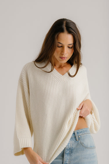 a woman in a white sweater