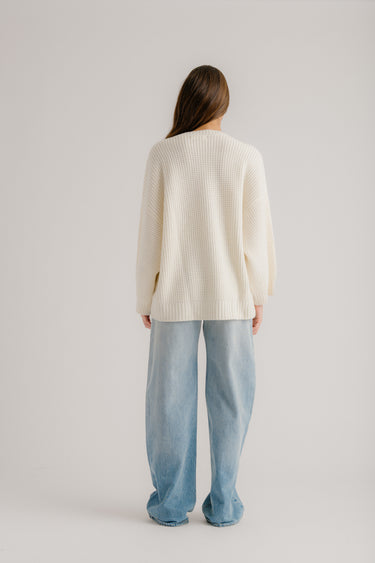 a woman in a white sweater